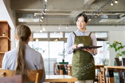 Preview: Asian employee carrying snacks at a restaurant
