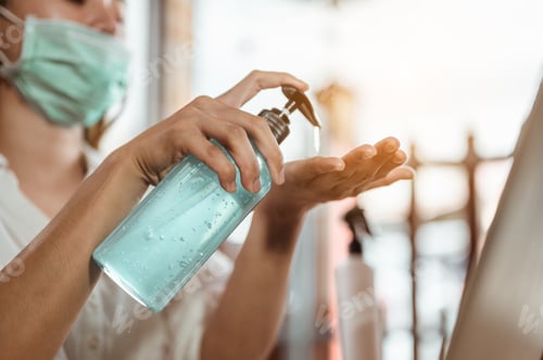 Preview: Office worker working from home during coronavirus outbreak cleaning her hands with sanitizer gel