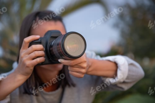 Preview: Close up of a girl makes a photo on a professional camera.