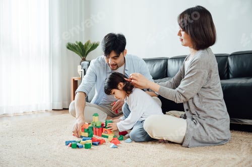 Preview: Happy family playing with building blocks at home