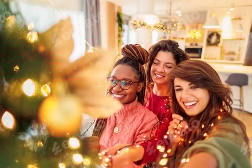 Preview: Three Smiling Women Decorating Christmas Tree