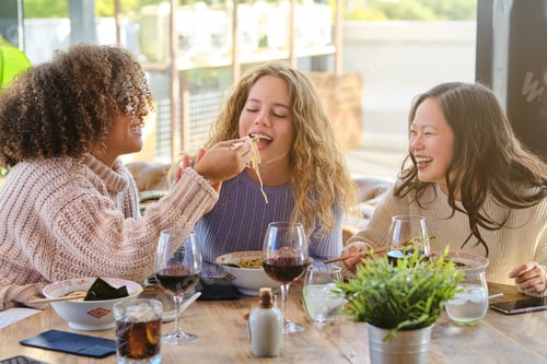 Preview: Diverse women having fun while eating ramen in restaurant