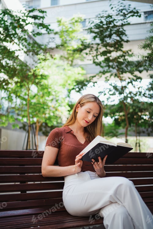 Preview: Student girl reading at the uni campus