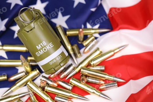 Preview: M18 smoke grenade and many yellow bullets and cartridges on United States flag