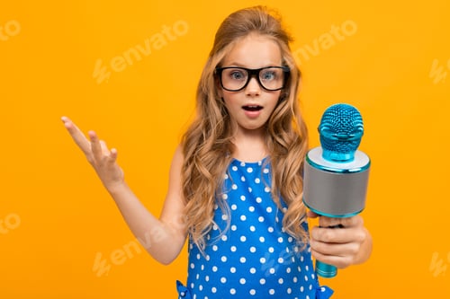 Preview: A little girl with glasses with a microphone is interviewed, the picture is isolated on yellow