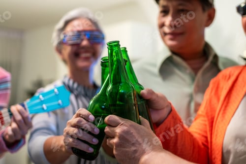 Preview: Group of Asian senior friend having evening party in living room at home.