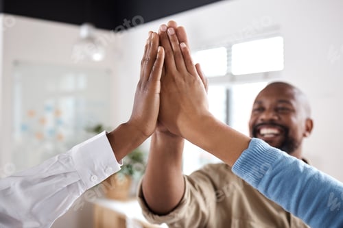 Preview: Shot of a group of businesspeople giving each other a high five in a modern office