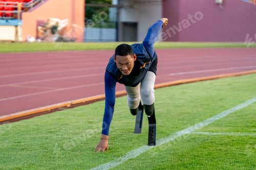 Preview: Asian para-athletes with prosthetic blades sprint on a running track at stadium.