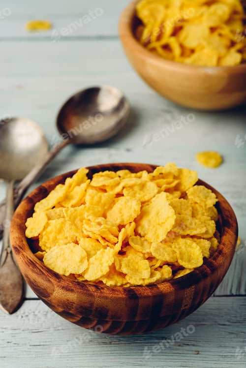 Preview: Rustic bowls of cornflakes with spoons