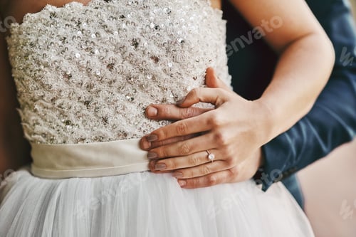 Preview: Cropped shot of a unrecognizable couple standing together on their wedding day