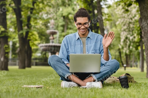 Preview: Young Man Video Calling Outdoors on a Laptop