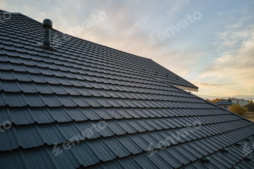 Preview: Closeup of house roof top covered with ceramic shingles. Tiled covering of building