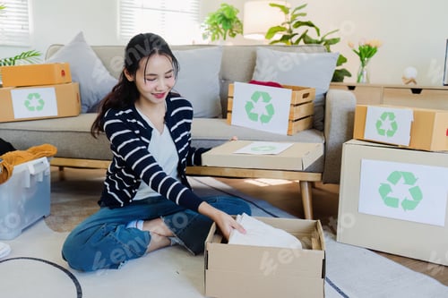 Preview: Asian women sort clothes from old clothing box to recycle. Recycling clothes concept