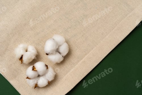 Preview: Textile eco bag and cotton flowers on paper background.