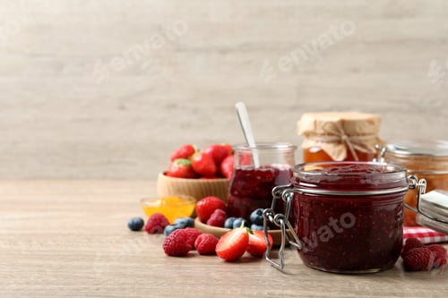 Preview: Jars with different jams and fresh fruits on wooden table. Space for text