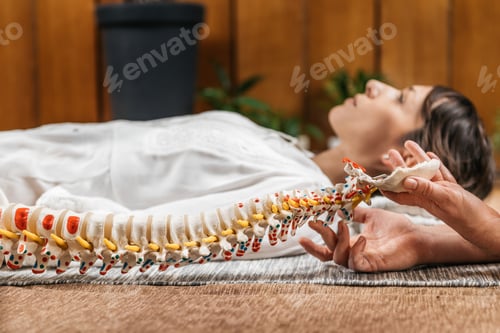 Preview: Woman Lying Down Receives Chiropractic Care