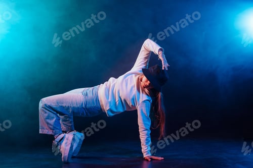 Preview: a girl in light clothes dances on a neon background in smoke, modern dance