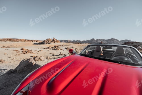 Preview: Convertible car on the roadside of the desert valley