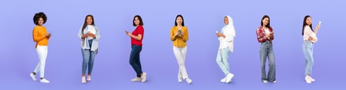 Preview: Smiling millennial diverse women in casual use phones, social networks app
