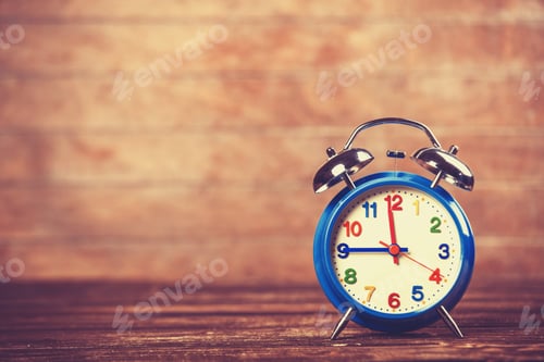 Preview: Retro alarm clock on a table. Photo in retro color image style