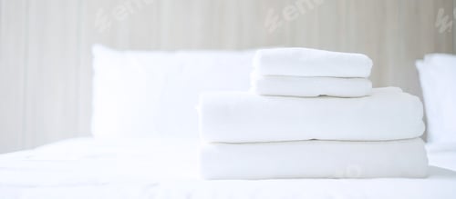 Preview: Stack of white towel and Bathrobe on bed in luxury hotel or resort. Laundry, Relax, holiday,