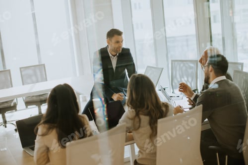 Preview: Young businessman presenting results to his coleagues in the office