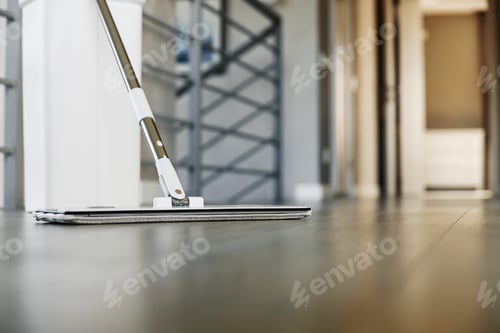 Preview: Cleaning supplies: mop and bucket with wringer on wooden laminate floor