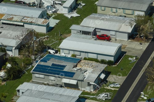 Preview: Badly damaged mobile homes after hurricane Ian in Florida residential area.