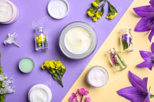 Preview: Flat lay composition with jars of body cream on color background