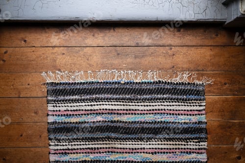 Preview: Multicolored rug on an old wooden floor. Top view.