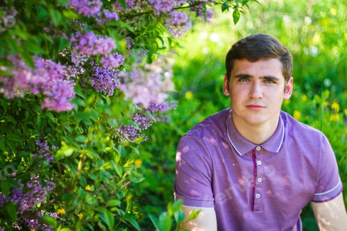Preview: Defocus caucasian man outdoors portrait in garden. Spring people. Young men in purple shirt on natur