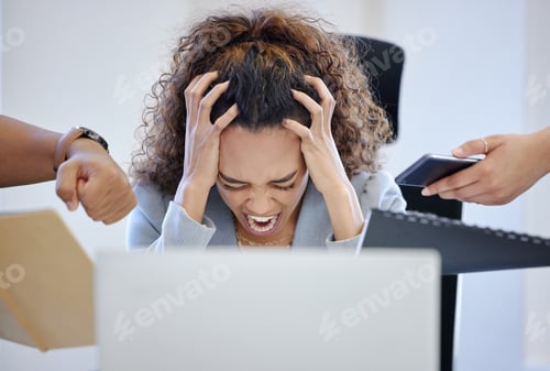 Preview: Shot of a young businesswoman looking overwhelmed in a stressful environment at work