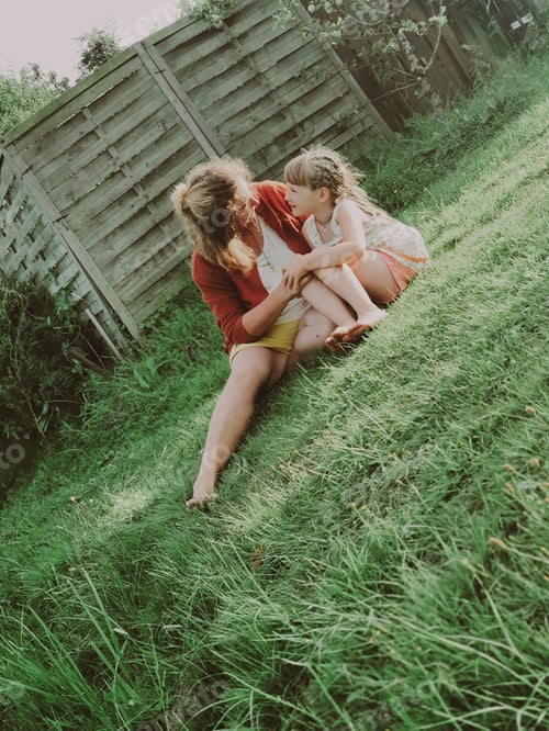 Preview: mother and daughter are relaxing in the garden. Family weekend. rest at nature