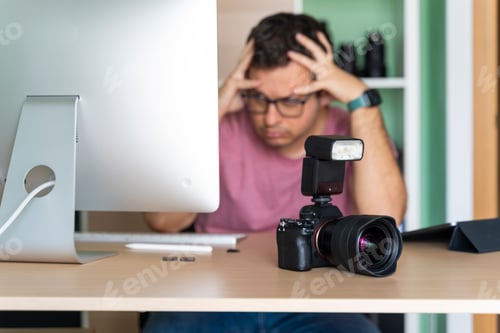 Preview: Man in his office worried about his photos on the computer