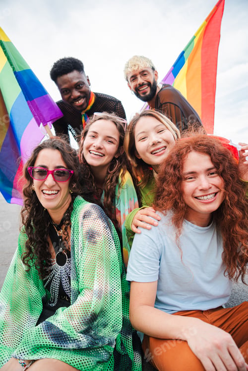 Preview: Vertical. Group of young LGBT poeple smiling celebrating together the gay pride day with a rainbow