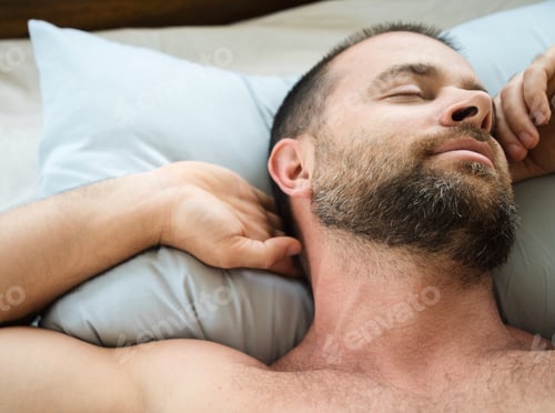 Preview: Bearded man sleeping in bed