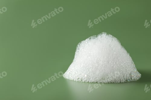 Preview: Drop of fluffy bath foam on olive background. Space for text
