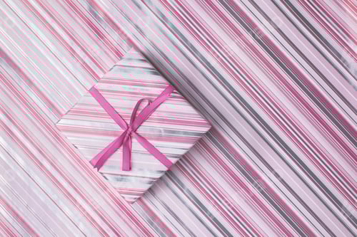 Preview: top view of christmas gift box with ribbon on patterned wrapping paper