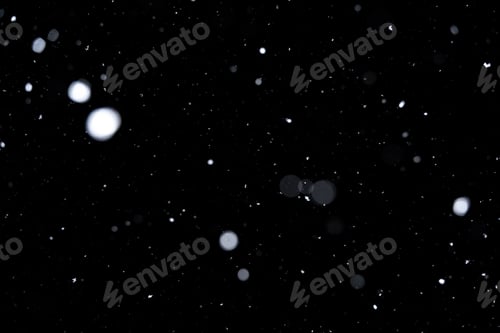 Preview: Element for winter design or overlay. Real snow over black background.