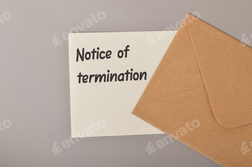 Preview: Brown envelope and white paper written with NOTICE OF TERMINATION.