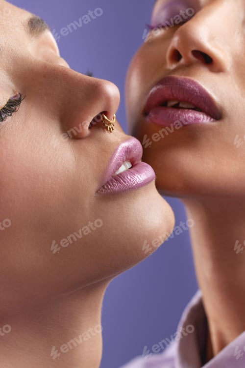 Preview: Dreams do come true. Cropped shot of two young women wearing purple make-up.
