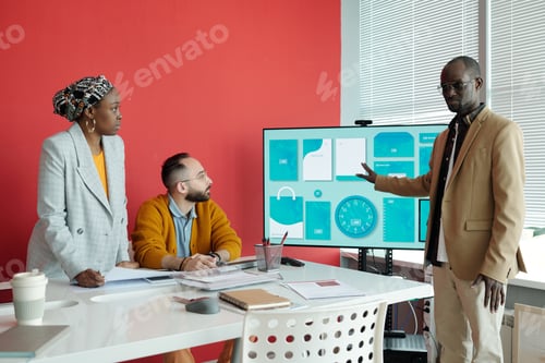 Preview: Team Engaged in Presentation in Modern Office