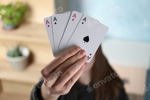 Preview: Woman with playing card against blurred background, closeup