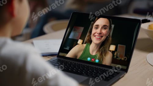 Preview: Smiling mother video calling child over shoulder view. Cheerful family talking