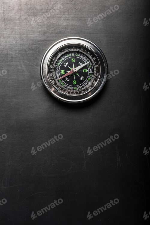 Preview: Compass on black board background