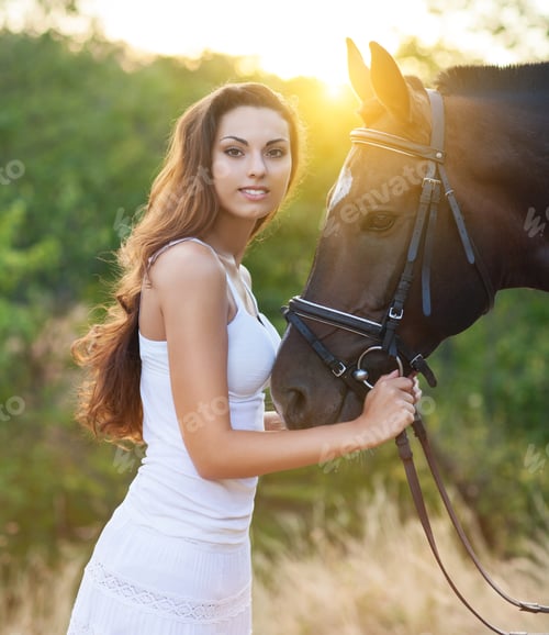 Preview: Beautiful happy woman with long hair next horse