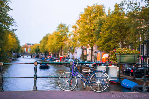 Preview: Bikes on the bridge in Amsterdam, Netherlands. Beautiful view of canals in autumn