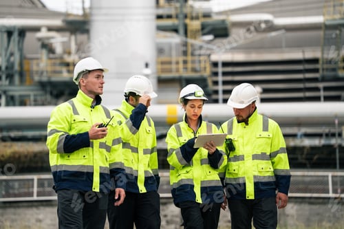 Preview: Group of engineer workers checking project at petrochemical factory