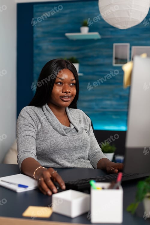 Preview: Smiling adult doing remote work with computer and keyboard