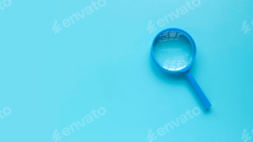 Preview: Blue magnifying glass over a blue background. Copy space